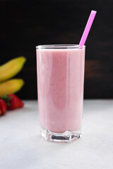 Strawberry and banana smoothie drink, blended cocktail, milkshake in a glass