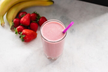 Strawberry and banana smoothie drink, blended cocktail, milkshake in a glass
