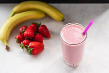 Strawberry and banana smoothie drink, blended cocktail, milkshake in a glass