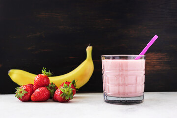 Strawberry and banana smoothie drink, blended cocktail, milkshake in a glass