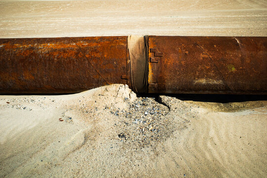 An exposed high pressure pipeline along a beach in Emerald Isle, North Carolina