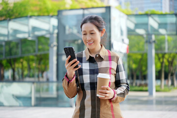 Professional Woman Enjoying Coffee and Smartphone in City