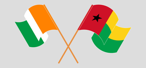 Crossed and waving flags of Ivory Coast and Guinea-Bissau