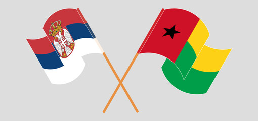Crossed and waving flags of Serbia and Guinea-Bissau