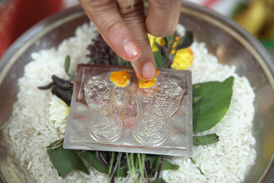 Paduka poojan, Indian Hindu pooja traditional holy rituals moments, chandan powder