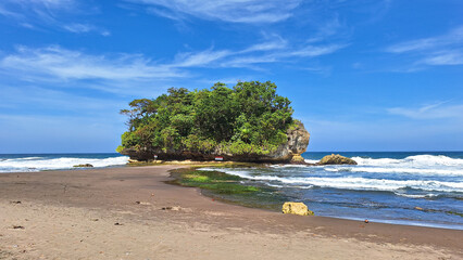 View of Madasari Beach with Coral Island with Cloudy Blue Sky Background in the Summer. © Rizky Rahmat Hidayat