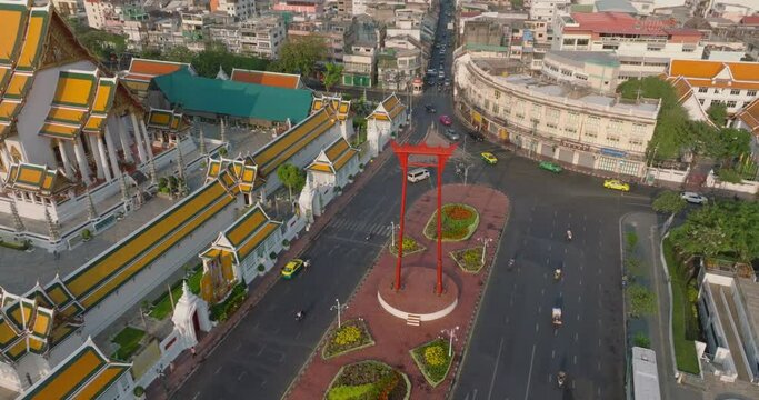 An aerial view of Red Giant Swing and Suthat Thepwararam Temple at sunset scene, The most famous tourist attraction in Bangkok, Thailand.