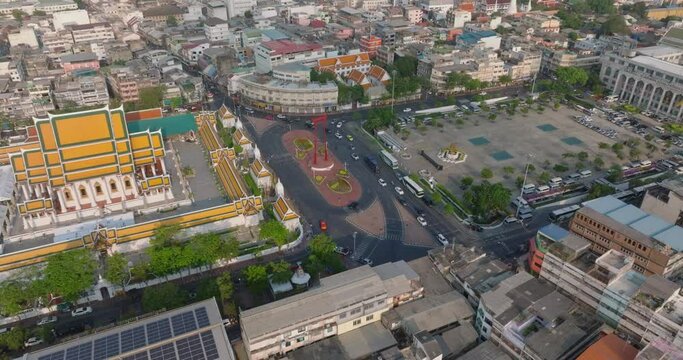 An aerial view of Red Giant Swing and Suthat Thepwararam Temple at sunset scene, The most famous tourist attraction in Bangkok, Thailand.