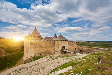 Ancient fortress in Khotyn in morning sun with mist, West Ukraine. Fortification on the banks of...