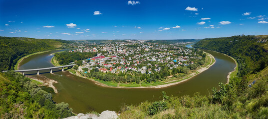 Top picturesque view of the spring Dnister river bend canyon and famous Ukrainian Zalischyky town. Ternopil region, Ukraine.