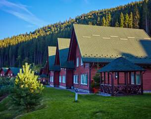 Cottage of winter ski resort Bukovel in Carpathian Mountains, Ukraine in Summer. Picturesque wooden...