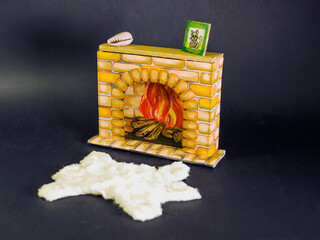 A miniature hand drawn sketch fireplace on black background. Background for postcards and children's books. Handmade, craft, hobby. The idea for the interior of the doll house. Furniture for dolls.