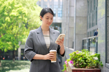 Professional Woman Using Smartphone on Coffee Break
