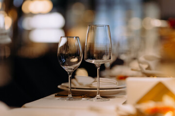 A close up shot of a restaurant table set up with tableware and wine glass. Concept of dining, hospitality and catering.