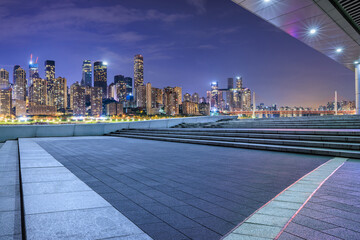 Pedestrian walkway and city skyline with modern buildings at night in Chongqing