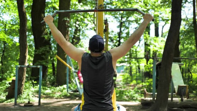 Seated lat pulldown exercise workout on outdoor gym