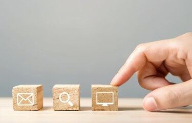 A hand touching wooden blocks and email marketing icon