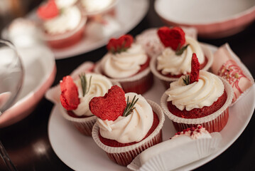 red velvet cupcakes with white buttercream and heart decoration