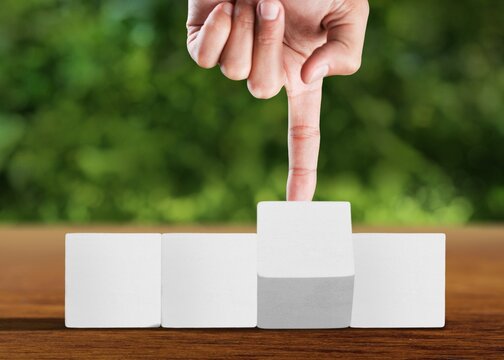 Hand turns wooden cubes changes the expression work to learn.