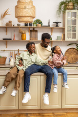 Playful small kids girl having fun with smiling bearded father at home