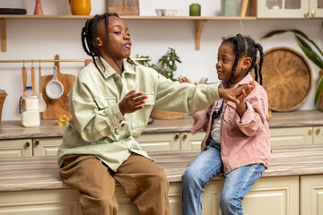 Little girl spending free time in company of best friend or sister having fun