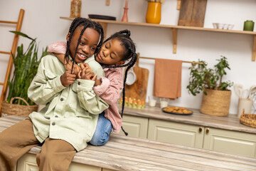 Children having fun enjoying playtime at home in kitchen
