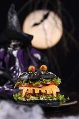 Monster Burger. Black bun, juicy beef cutlet, lettuce, onion, tomato and cheese in the shape of...