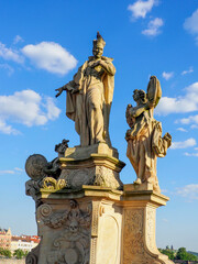 Obraz premium Isolated view of the 18th century monument of St Francis Borgia with two angels. Charles Bridge. Moody, overcast cloudy sky background.
