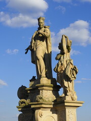 Obraz premium Isolated view of the 18th century monument of St Francis Borgia with two angels. Charles Bridge. Moody, overcast cloudy sky background.