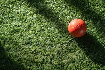 Toy football, rule of thirds, space for text, on artificial grass background