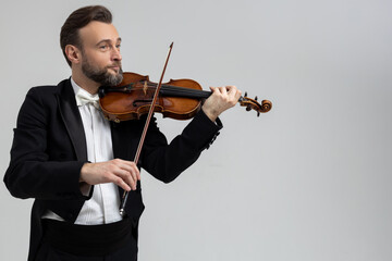 Bearded violinist playing classical music at concert