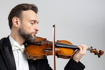 Handsome man artist playing violin