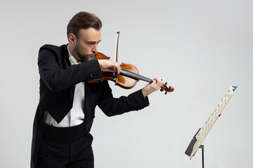 Professional violinist with notes playing classical music