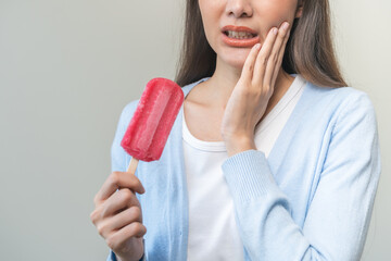 Face expression suffering from sensitive teeth and cold, asian young woman, girl hand touching...