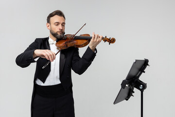 Professional violinist with notes playing classical music