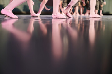 A group of children, many legs are standing on the stage. Children performing art on stage....