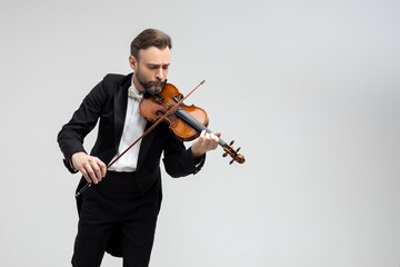 Handsome man artist playing violin