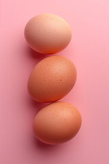 Fototapeta premium Top view of boiled eggs on pink background