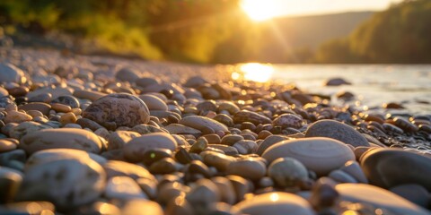 Obraz premium Golden Hour Pebble Beach Sunset Scene with Soft Focus and Warm Light