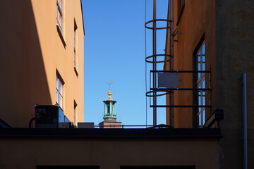 A tower seen between two buildings