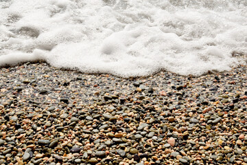 the waves of the sea run to the sandy shore