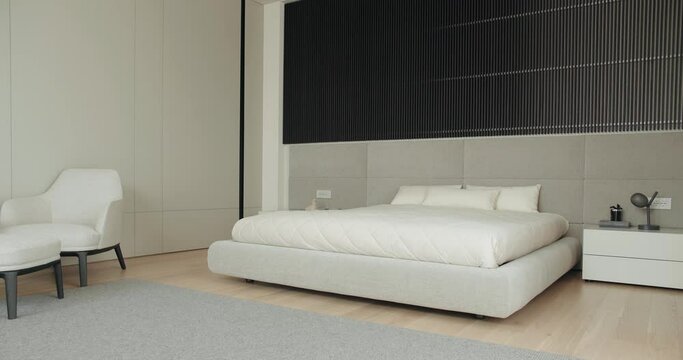 A stylishly appointed bedroom featuring a modern aesthetic with a large bed, plush chair, and minimalist decor. Elegant Modern Bedroom With Neutral Palette And Design Furniture