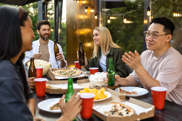 Happy friends having fun outdoor toasting beer glasses celebrating pleasant event