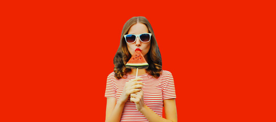 Summer portrait of stylish young woman with juicy lollipop or ice cream shaped slice of watermelon