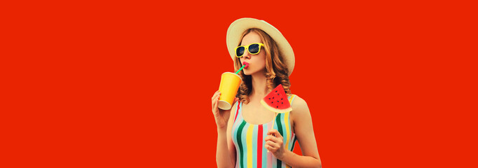 Summer portrait of young woman drinking juice with lollipop watermelon on red background