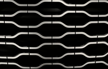 Black metal grid with a repeating geometric pattern.