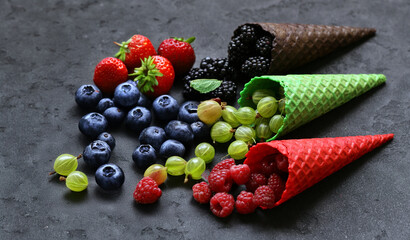 assorted ice cream of different flavors in waffle cones