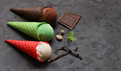 assorted ice cream of different flavors in waffle cones