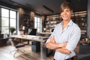 Portrait of a young businessman standing in modern office