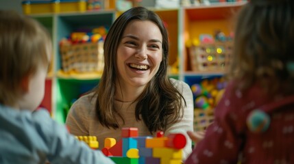 A woman is smiling at a group of children playing with